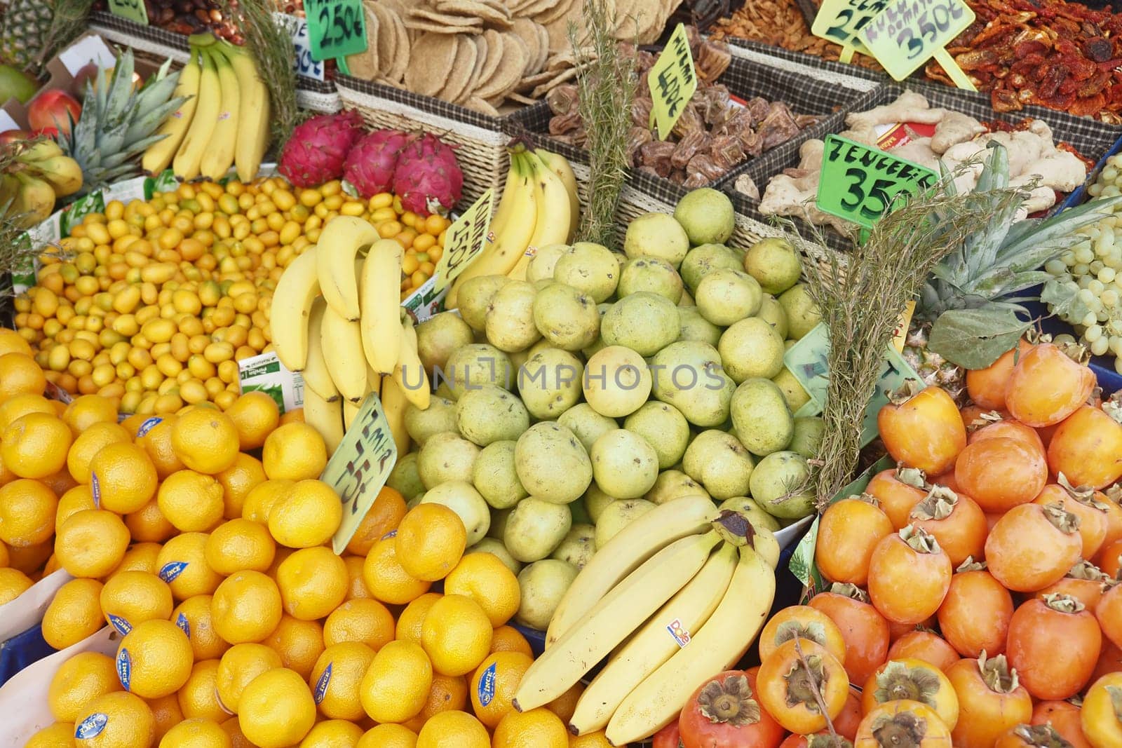 Fresh fruits and vegetables are artistically arranged at a local market.