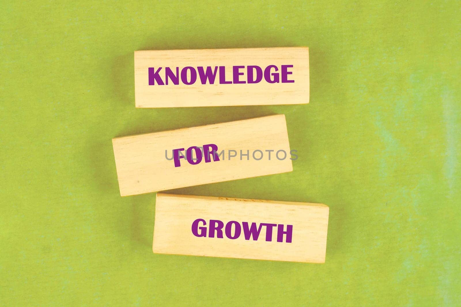 Blocks display the phrase presenting knowledge as essential for individual and societal growth in education and development contexts.