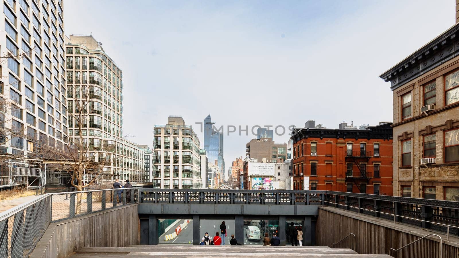 Manhattan, New York, USA - February 16, 2024: View of the Hight Line with its typical buildings seen from above as people visit on a gray winter day