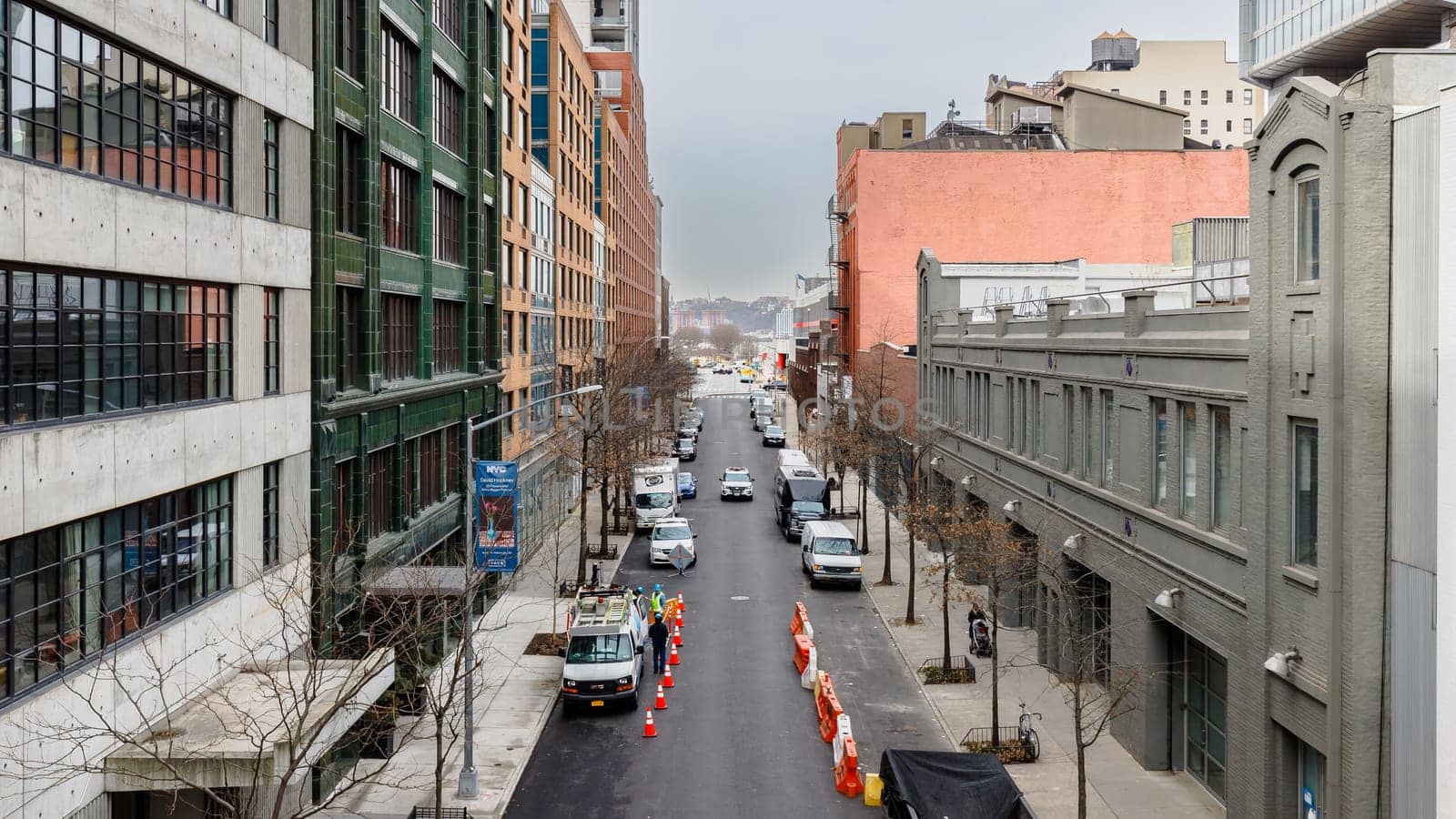 Manhattan, New York, USA - February 16, 2024: View of the Hight Line with its typical buildings seen from above as people visit on a gray winter day