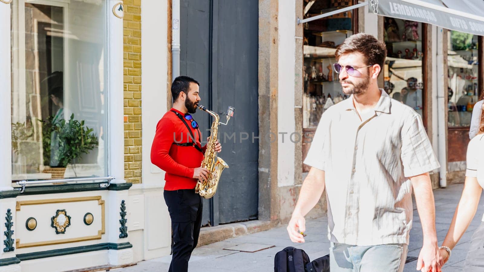 Braga, Portugal - May 26, 2024: Saxophonist playing in a street of the historic city center during the Braga Romana event
