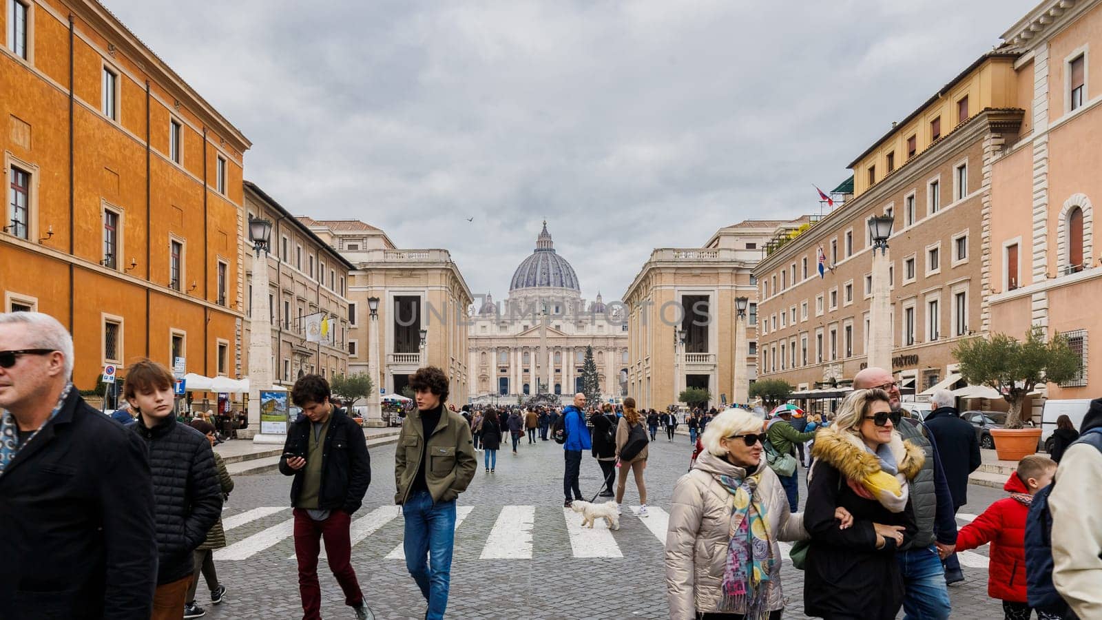 Vatican City, Vatican - December 29, 2023: View of Conciliation Street in front of St. Peter's Basilica in San Pietro Square (Saint Peter's Square) where tourists are walking on a winter day