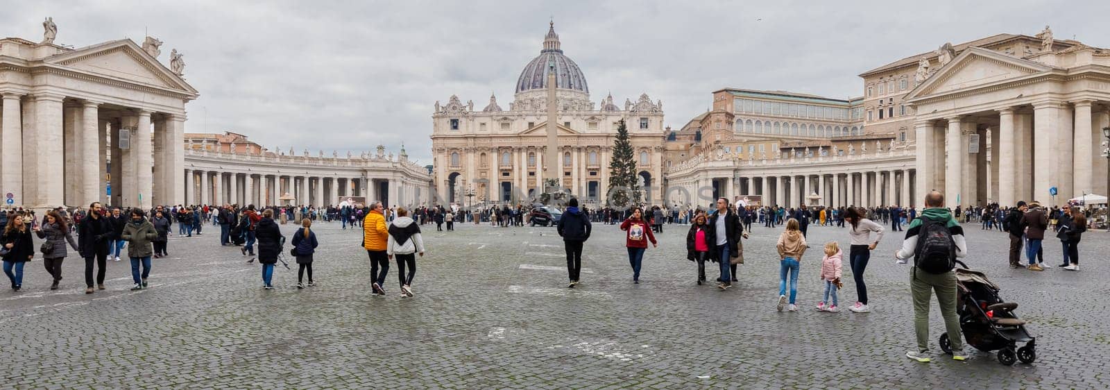 Vatican City, Vatican - December 29, 2023: Street atmosphere in San Pietro Square (Saint Peter's Square) where tourists are walking on a winter day in bad weather