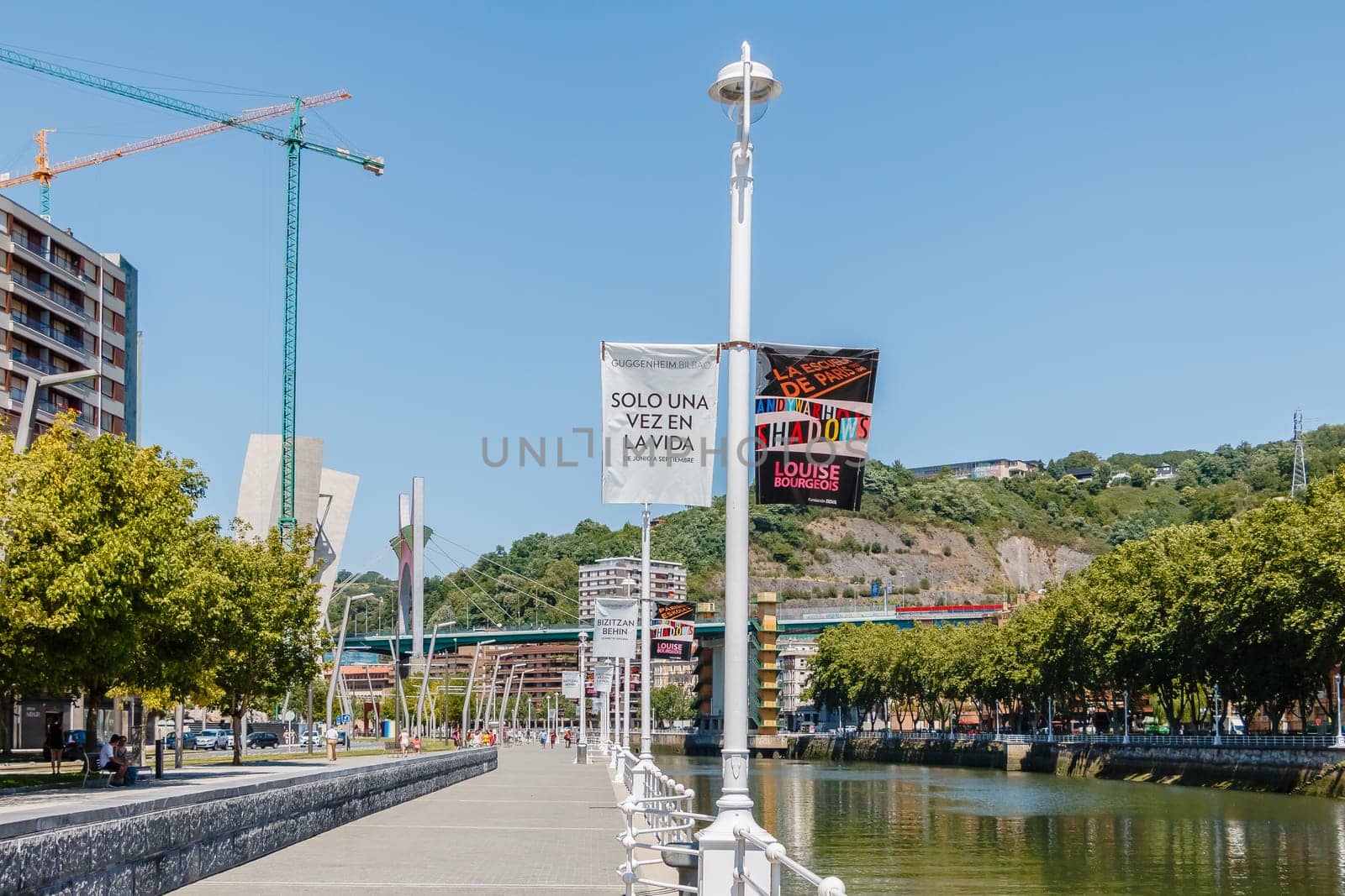 Bilbao, Spain - July 19, 2016: Banks of the Nervion River and its surroundings in the city center on a hot summer day