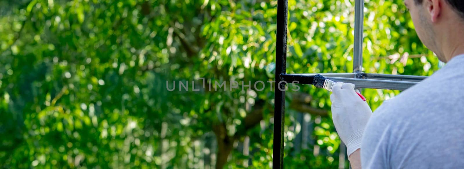 close up of painting metal with brush in garden