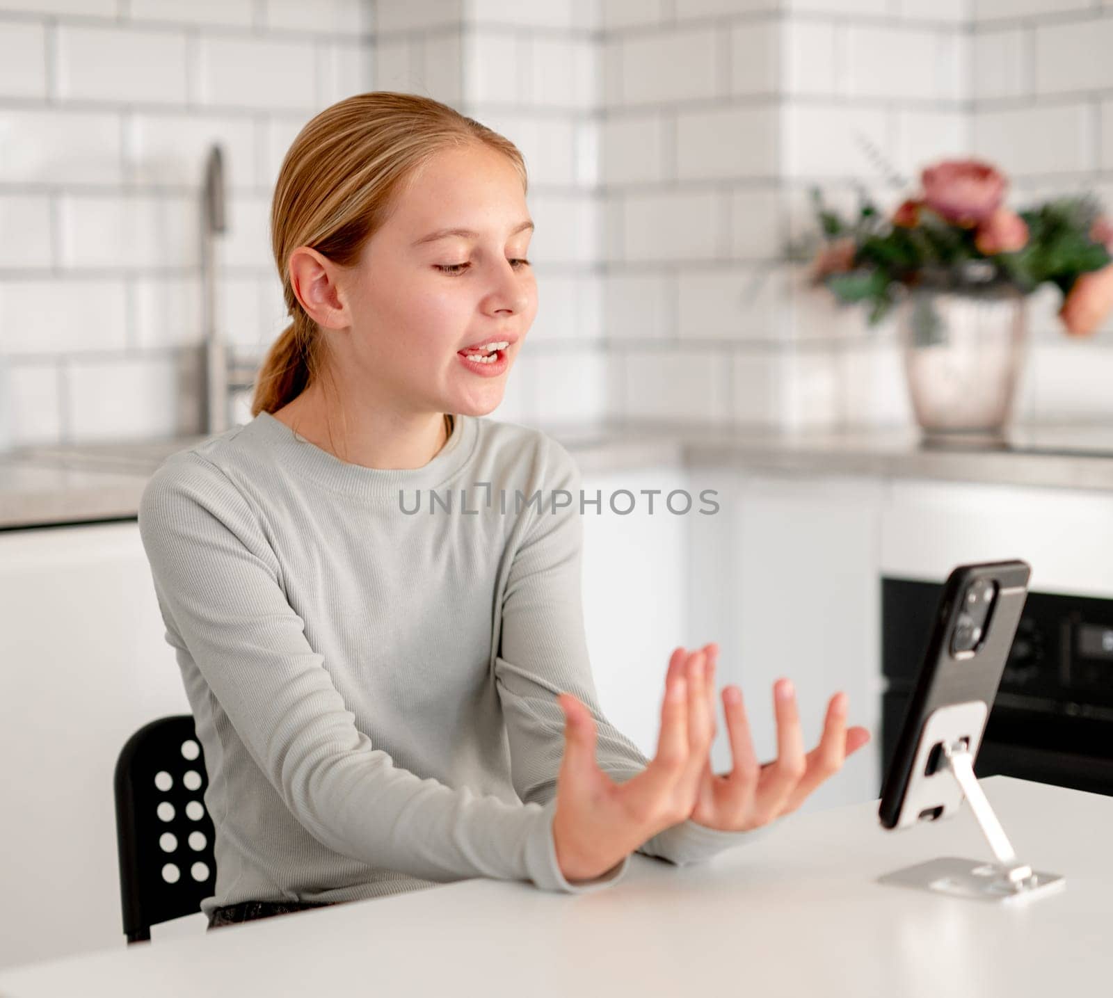Cute Little Girl Talking On A Video Call Using A Smartphone And Explaining Something
