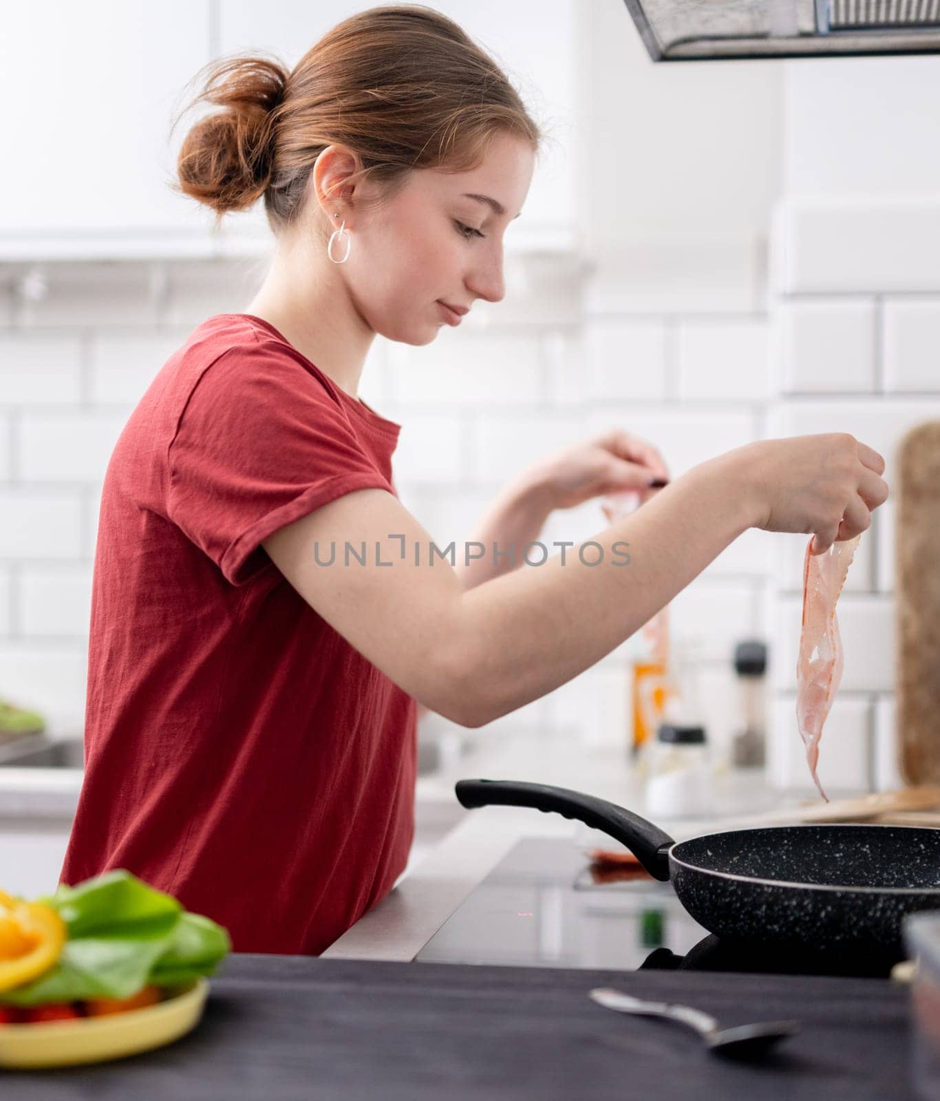 Sweet Girl Cooks Bacon In The Kitchen At Home