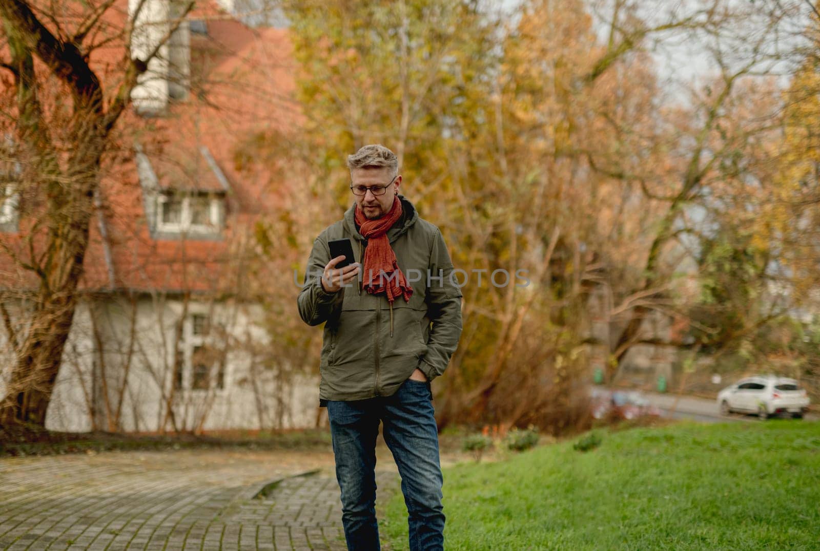 Young, Attractive Man On A Street Using Smartphone