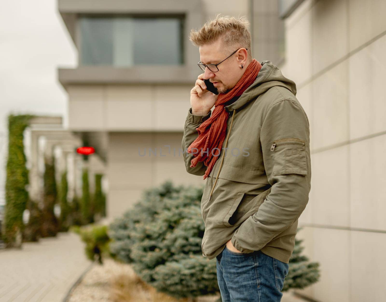 Stylish Young Man On The Street Having A Business Phone Call