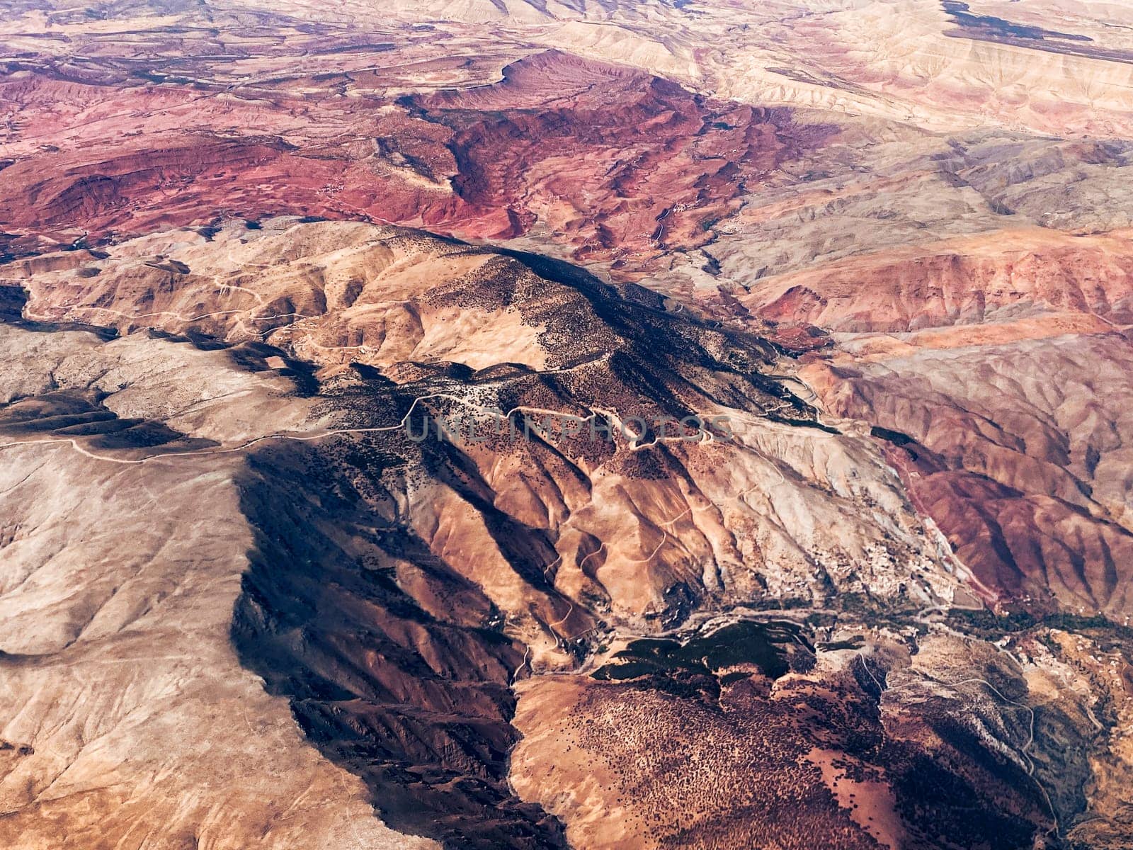 Aerial view of high desert mountains. Mountain landscape. Beauty in nature. Inaccessible mountain peaks. Harsh climate. Looking at the Earth from an airplane window. Aerial view of the land. Africa land
