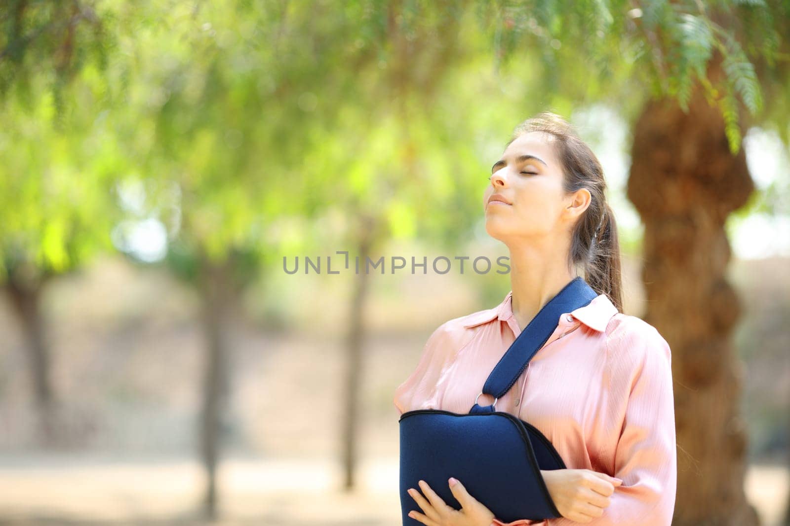 Convalescent woman breathing fresh air in a park