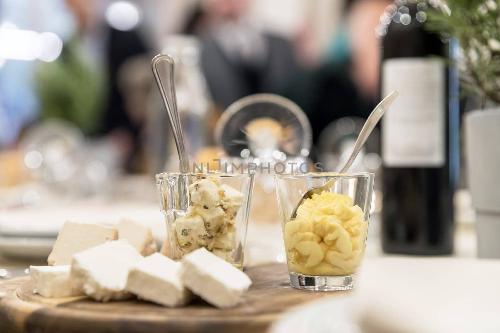 Wooden plate with cheese and sauces. Antipasti. Party. Events.