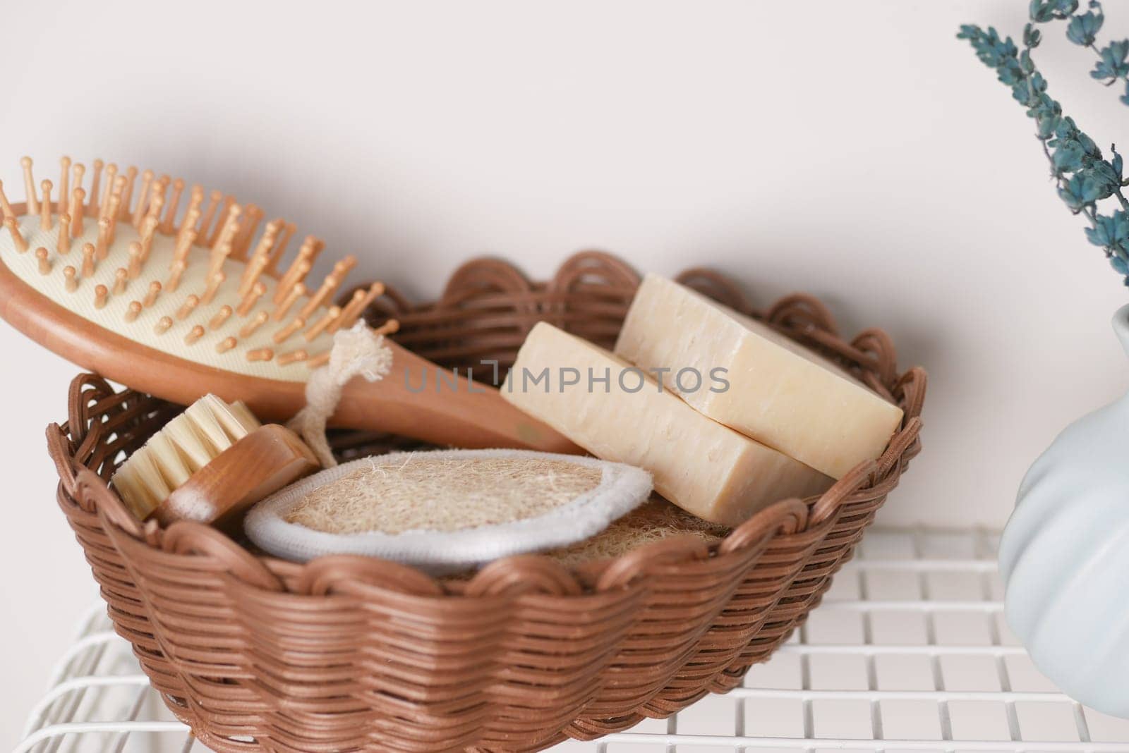 Various skincare items including soap, a brush, and a scrub sit neatly arranged.
