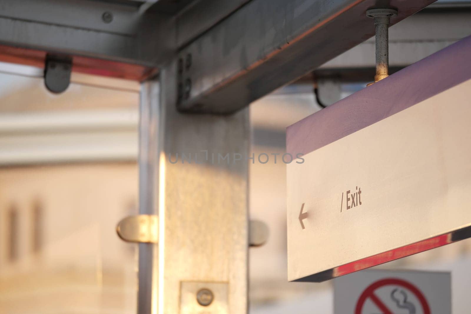 Sign indicates exit direction at a busy urban transit station.