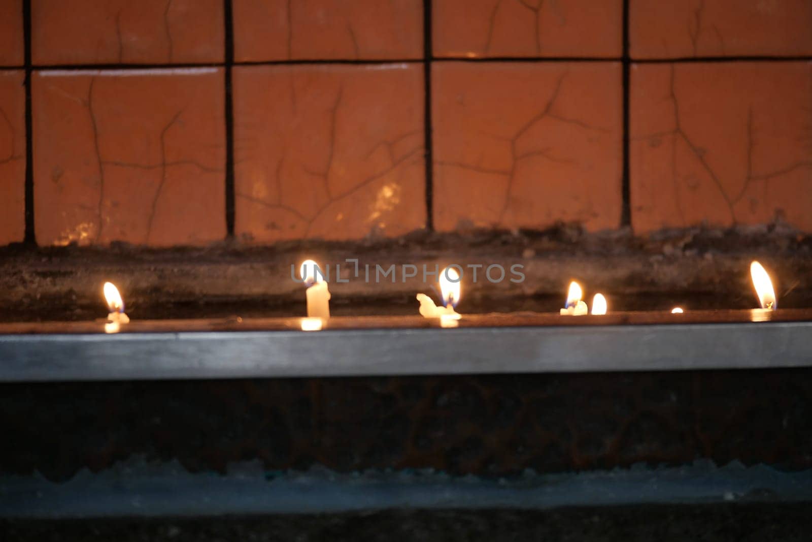 Soft candlelight illuminates a ledge in a tranquil atmosphere.