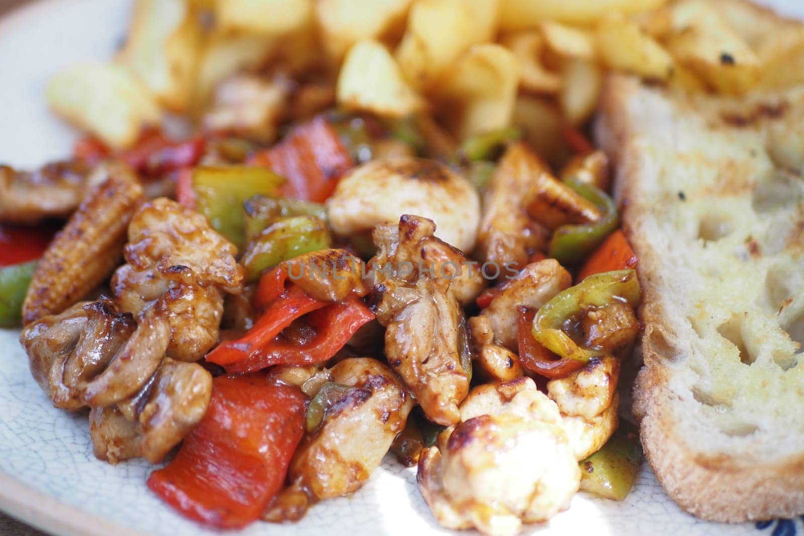 Delicious chicken stir-fry with colorful vegetables and crispy fries