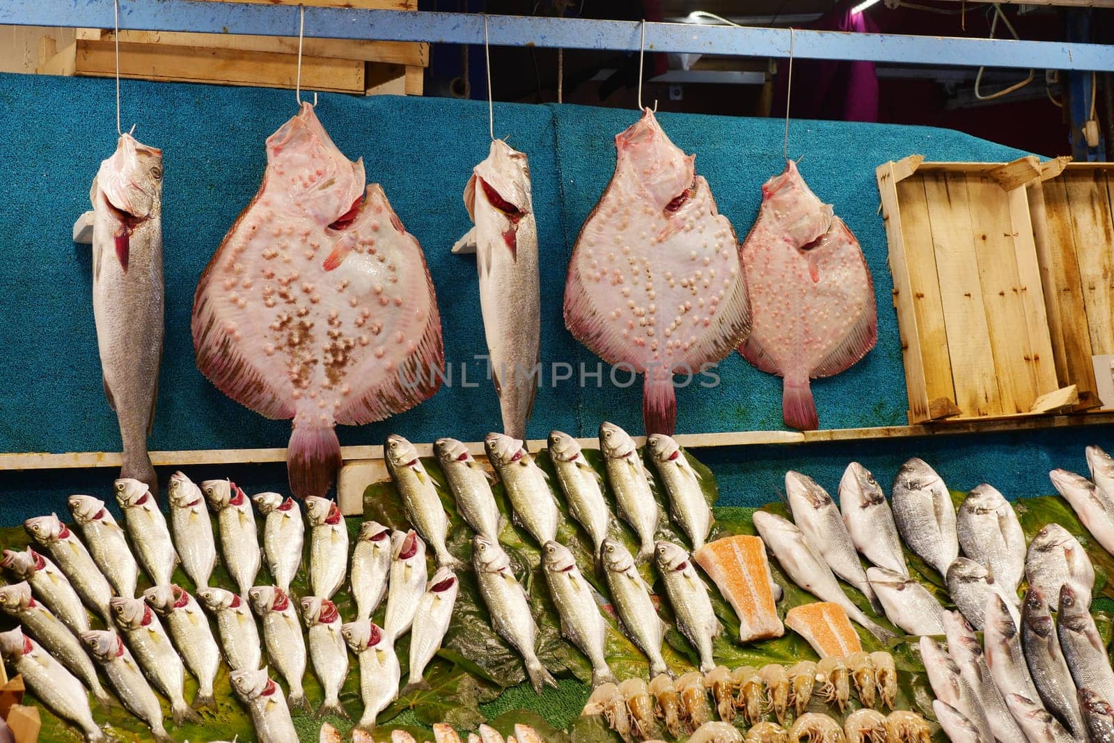 Fishmongers showcase a variety of fresh seafood in vibrant colors.