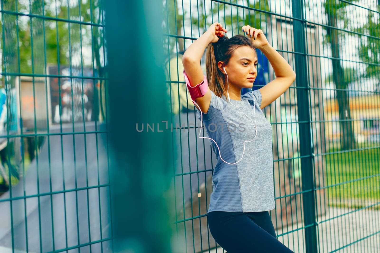Pretty young woman having exercise outdoors