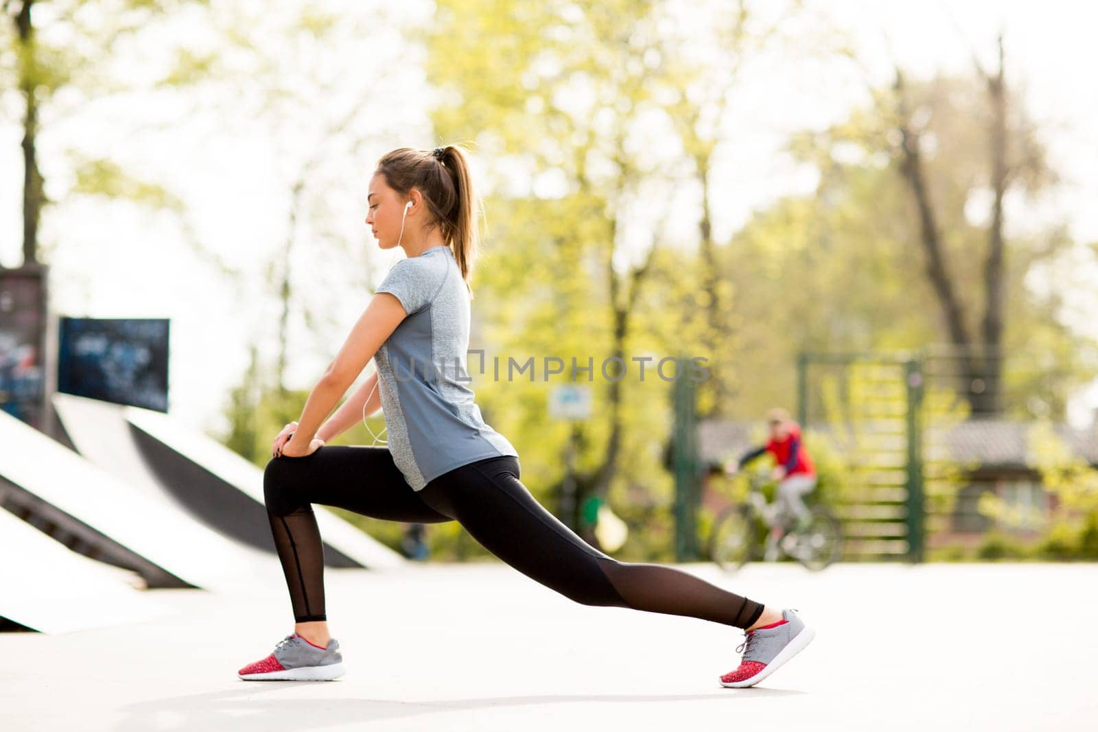 Pretty young woman having exercise in the park on a sunny day
