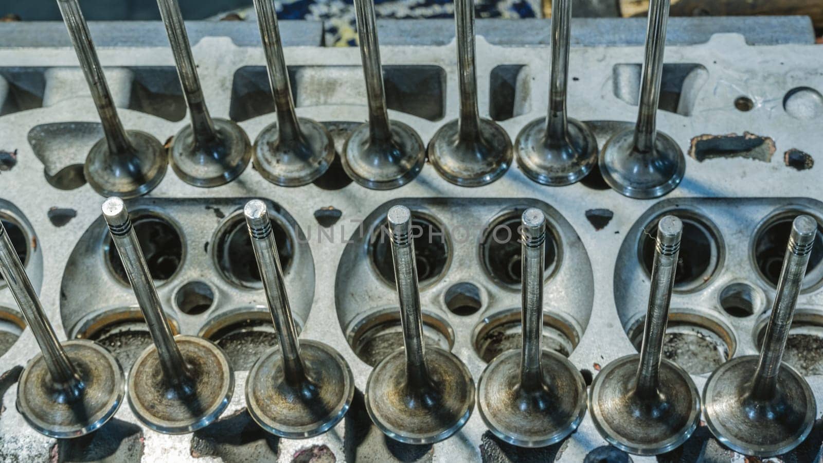 Car engine valves close up.Part of car's motor.Machinery detail of modern gasoline engine repair of cylinder head.Installing the valve of an overhauled engine.Mechanism automobile.Workshop motor car