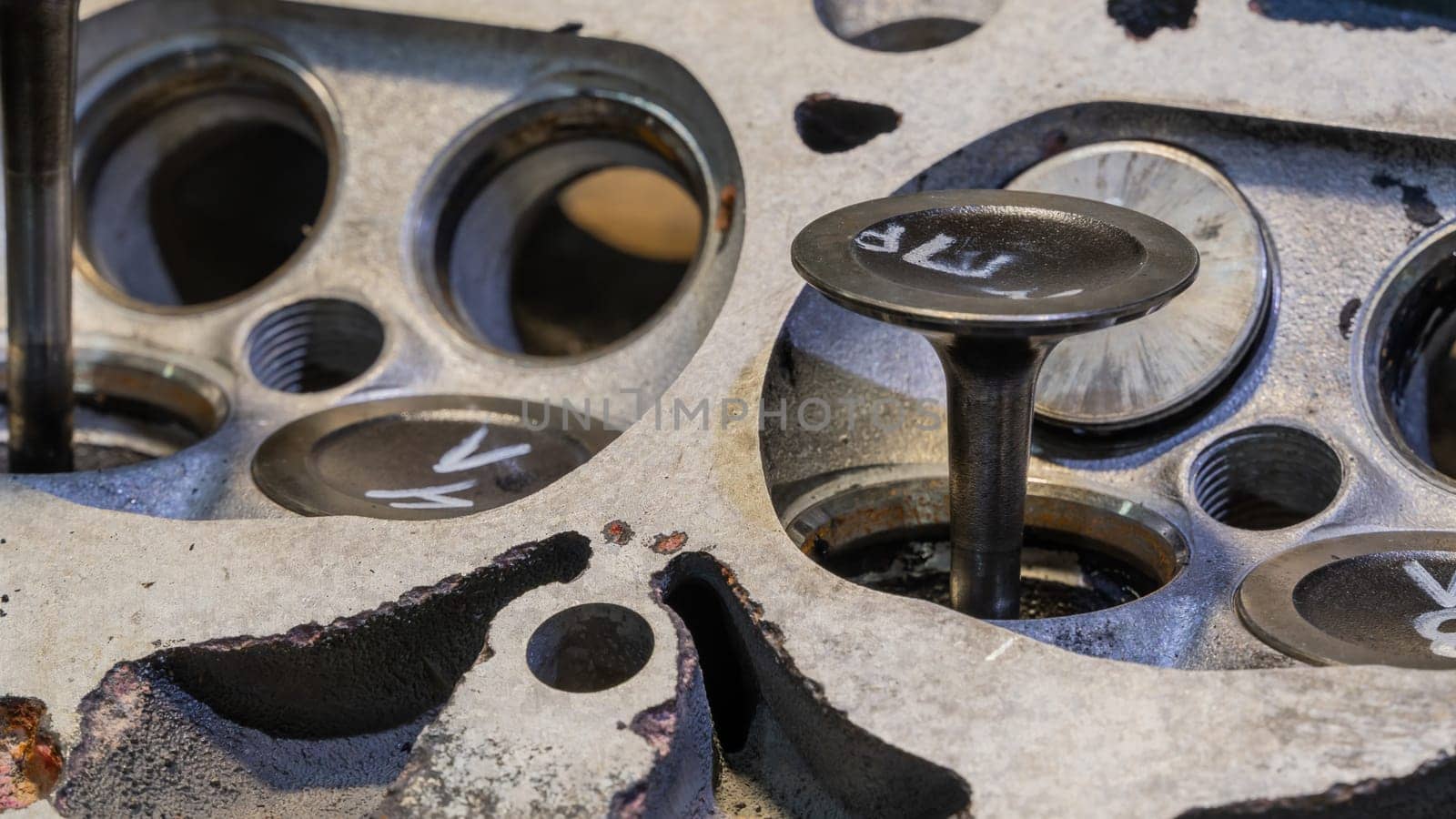 Car engine valves close up.Part of car's motor.Machinery detail of modern gasoline engine repair of cylinder head.Installing the valve of an overhauled engine.Mechanism automobile.Workshop motor car