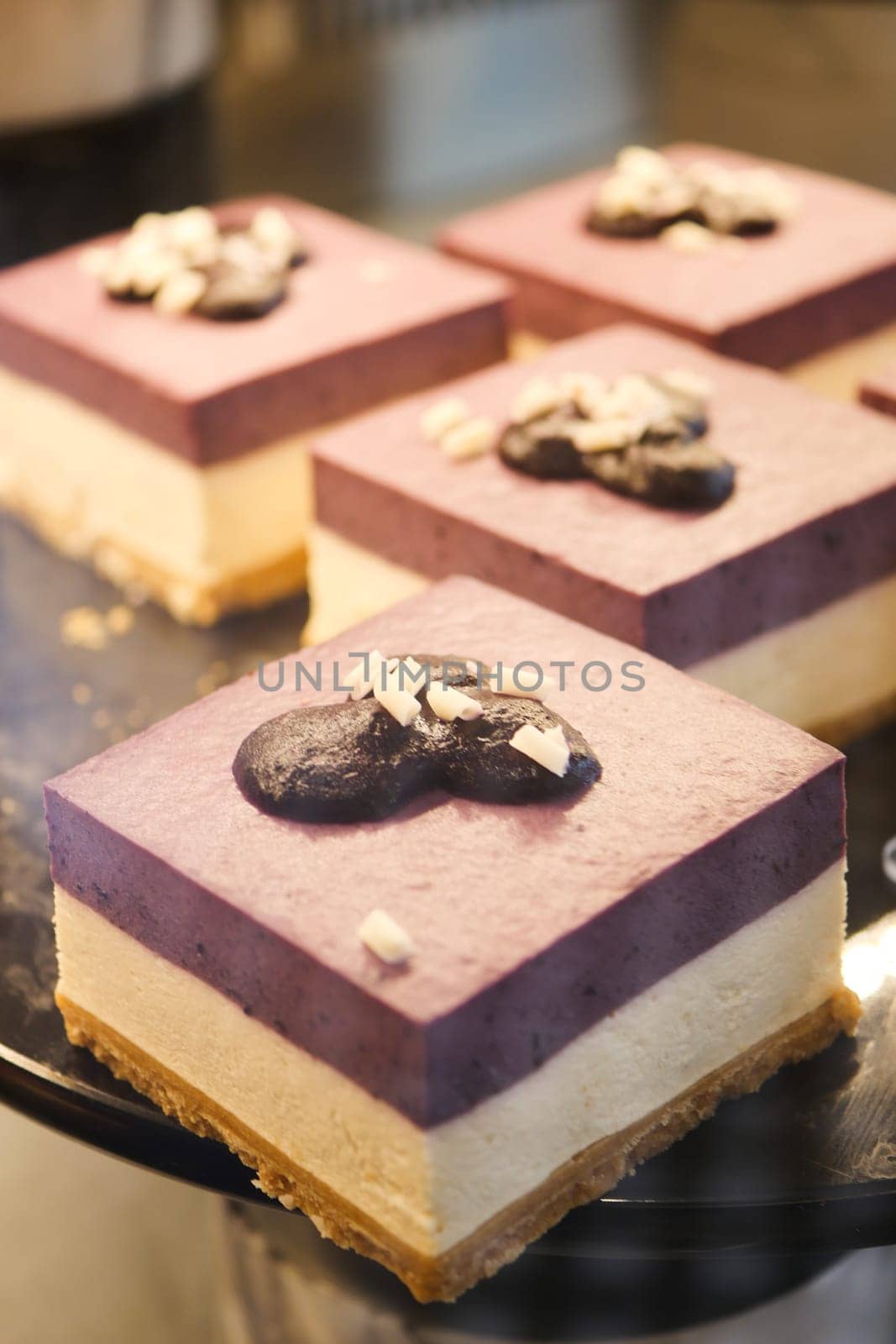 Colorful dessert with layers of blueberry, cream, and cookie crust showcased.