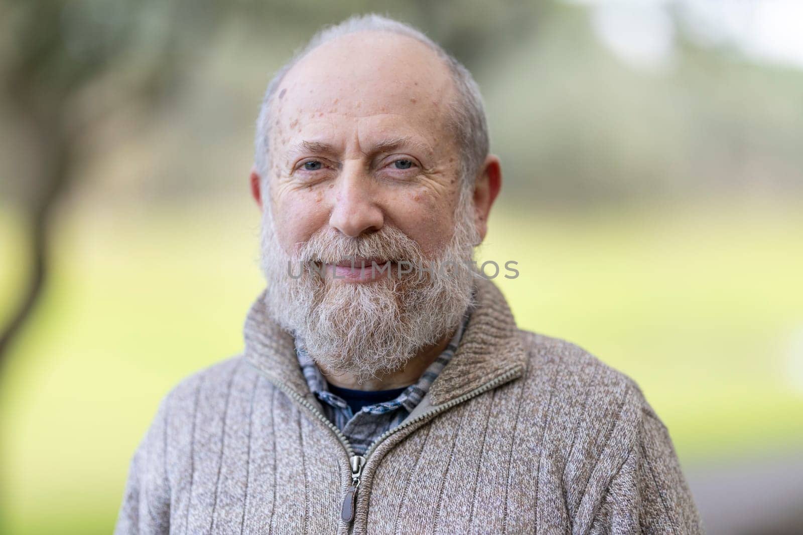 Cheerful retired professor enjoys retirement in a peaceful university garden setting