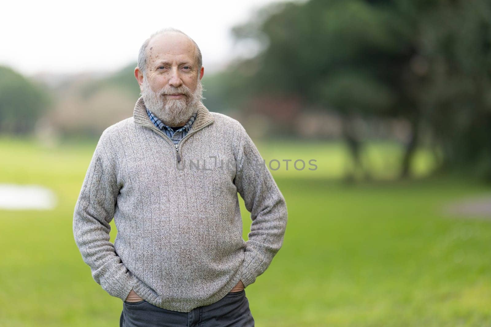Portrait of a confident, relaxed senior man enjoying a leisurely day in the park, embodying a sense of peace and contentment