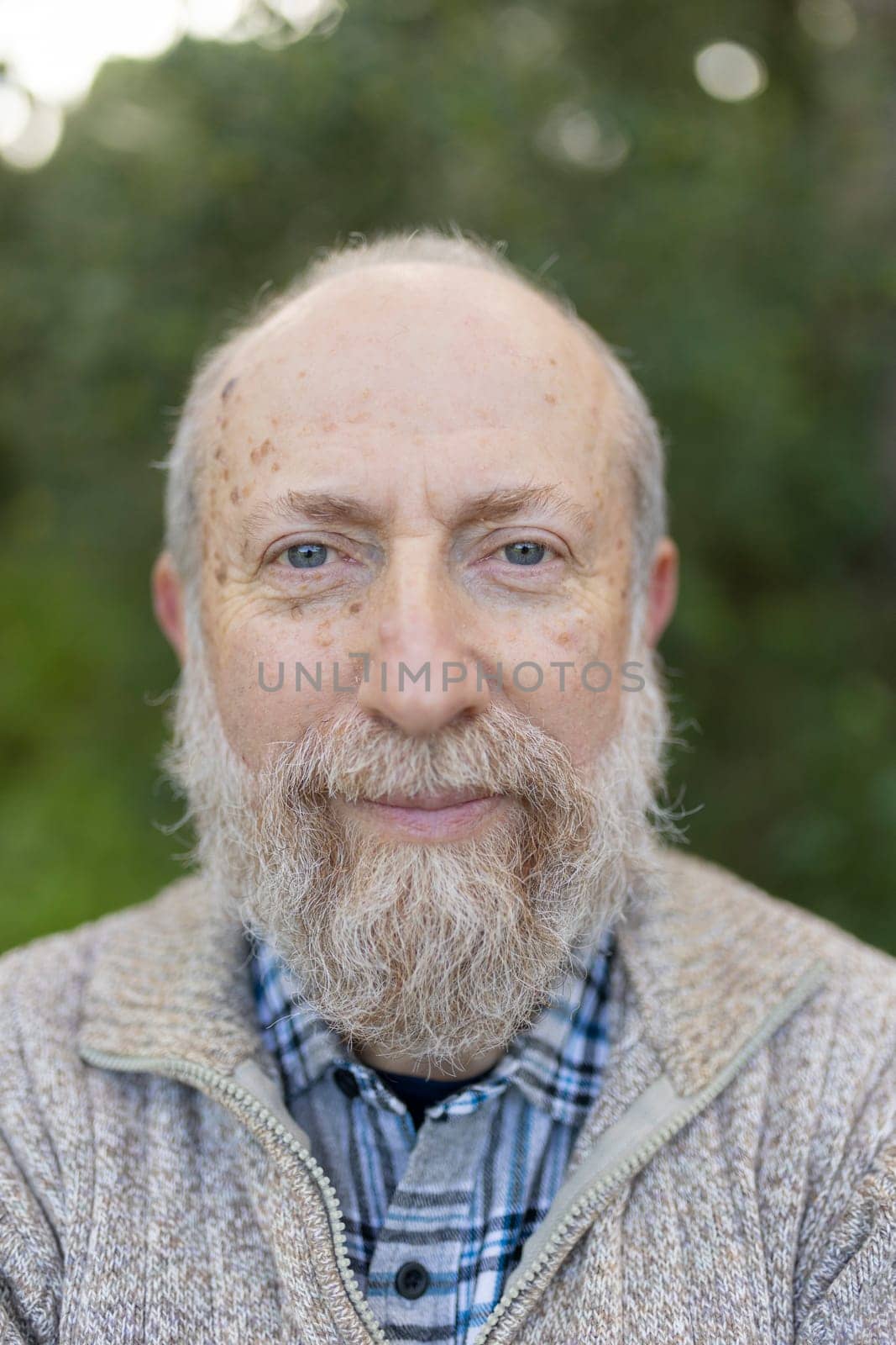Cheerful retired man enjoying peaceful nature, showcasing healthy aging and wisdom