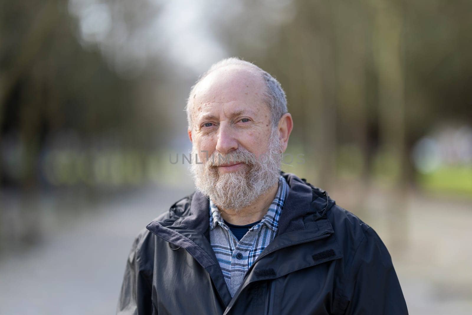 Content senior man enjoying peaceful retirement in a serene park setting