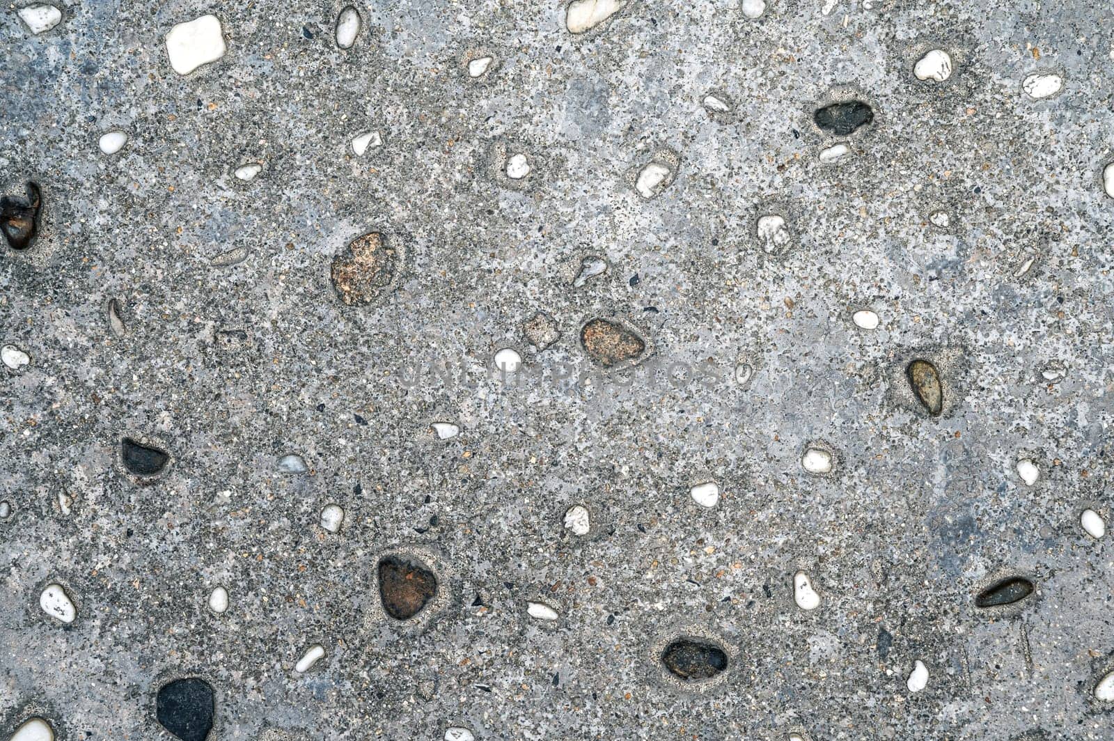 texture of gray asphalt with stones. Sidewalk background
