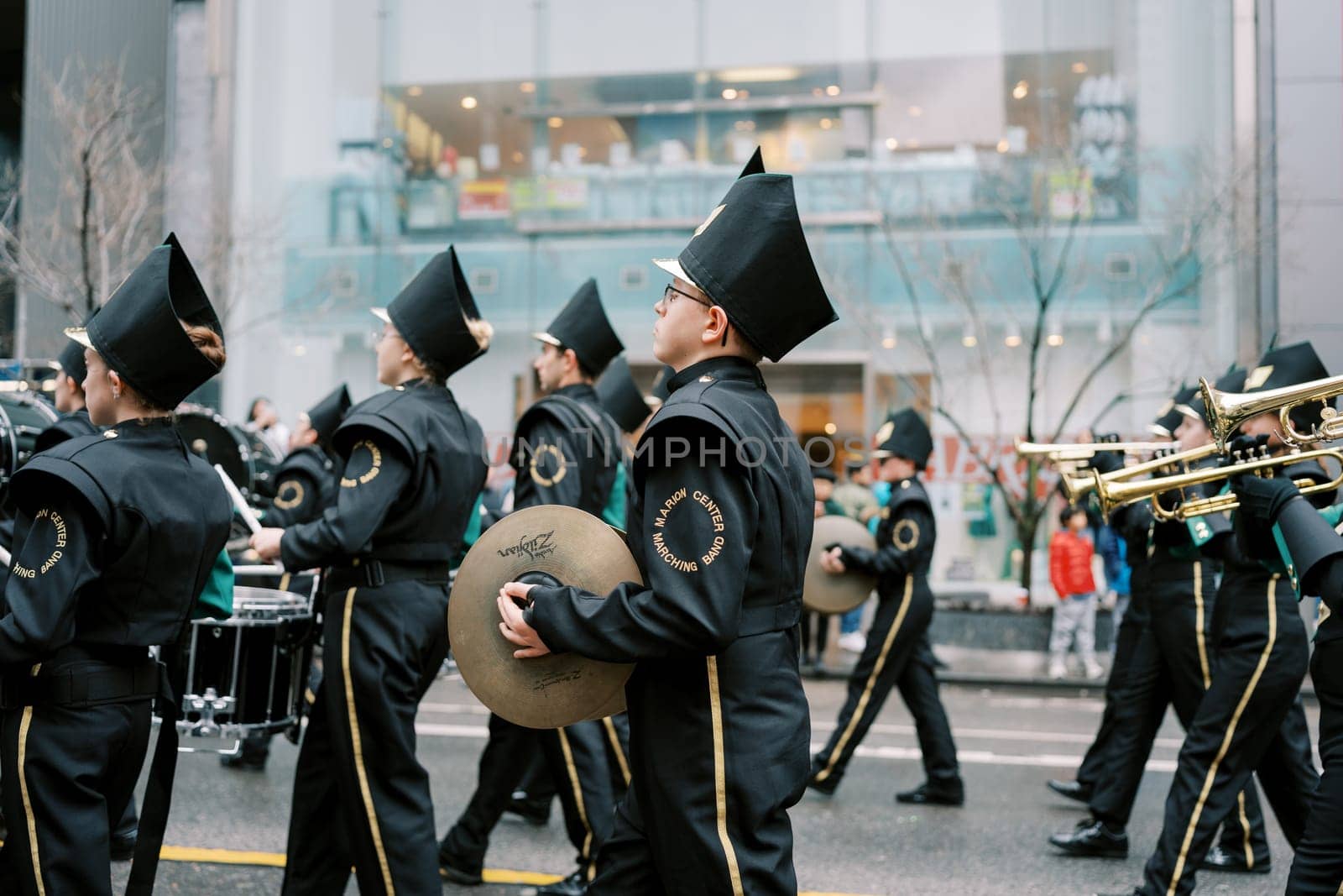 A vibrant marching band showcases exceptional skills at a city parade, full of joy