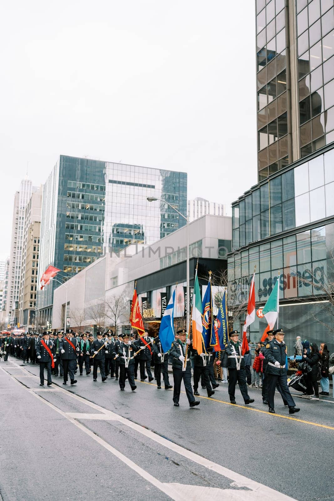 A lively parade showcasing colorful flags and enthusiastic participants in the city