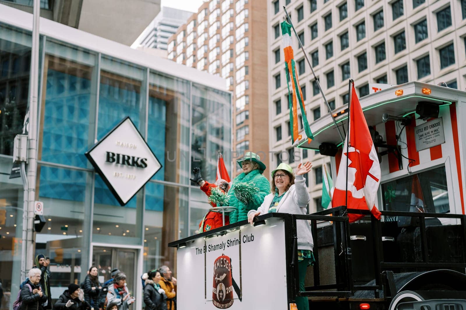 Participants celebrate St Patricks Day with colorful flags and costumes in unity