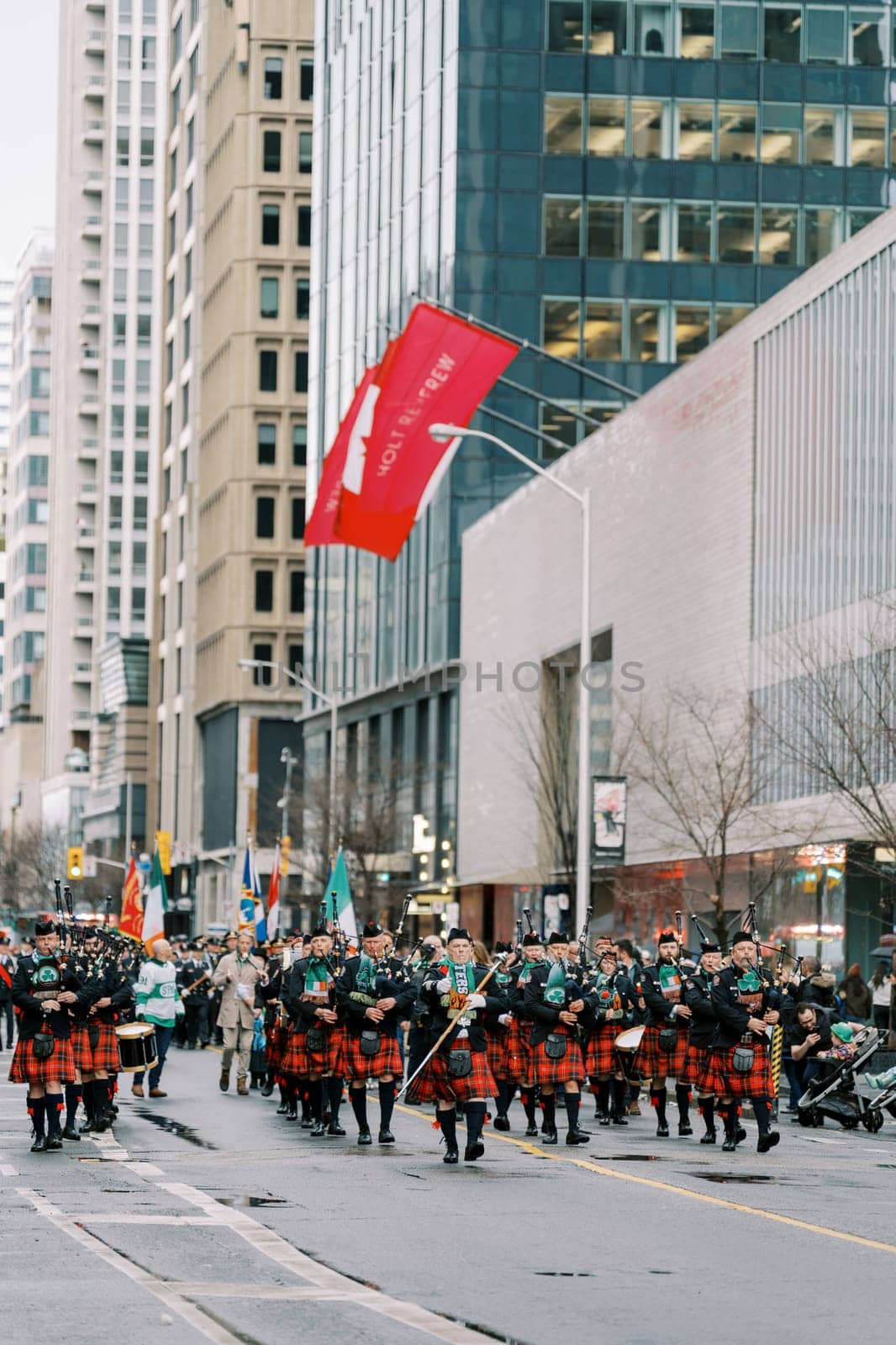 Festive city parade showcasing bagpipers and dancers in traditional attire