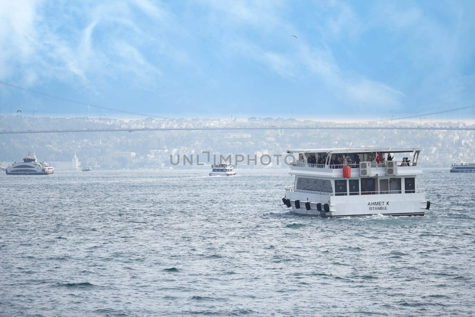 A boat navigates the waters near Istanbul under a blue sky.