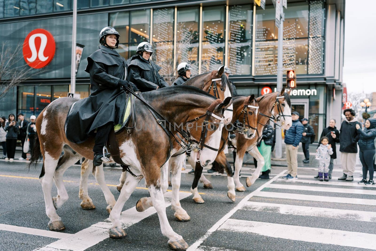 Police on horseback skillfully navigate city streets during a large event