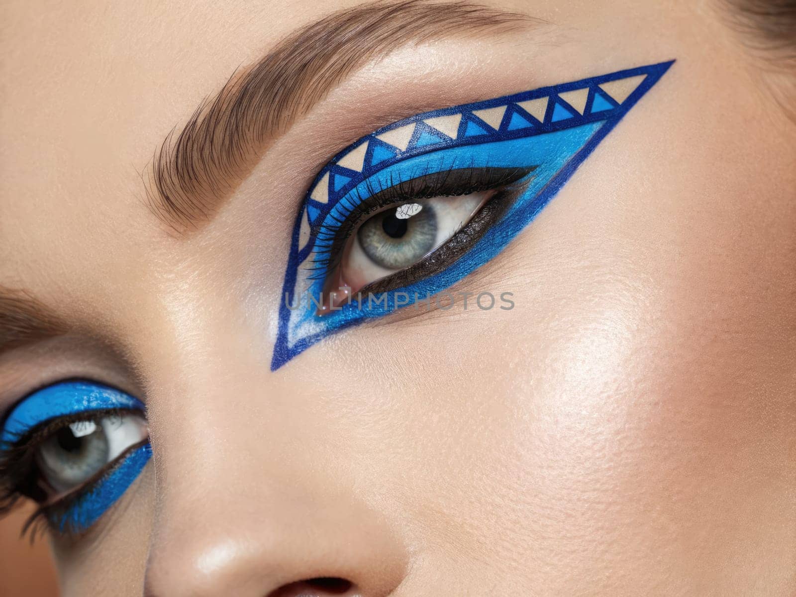 Intricate blue geometric patterns decorate striking eyes, showcasing bold artistry in a professional makeup session. The creative use of color and shapes brings energy to the look.