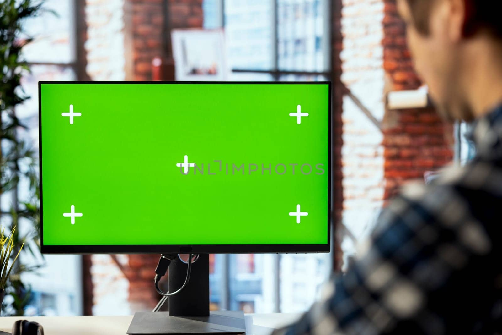 Man in workspace engaging in online training session on isolated screen PC, navigating course modules. Employee in home office watching instructional company videos on mockup computer monitor, closeup