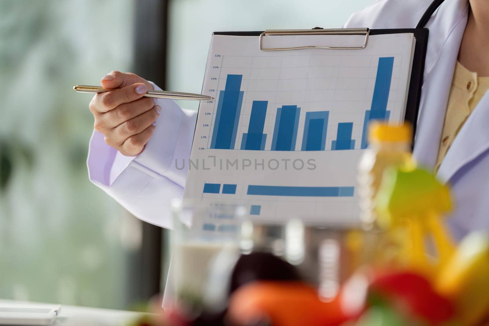 A well-dressed doctor showcases bar graphs on a clipboard, emphasizing the importance of nutritional monitoring for patients in a professional setting.