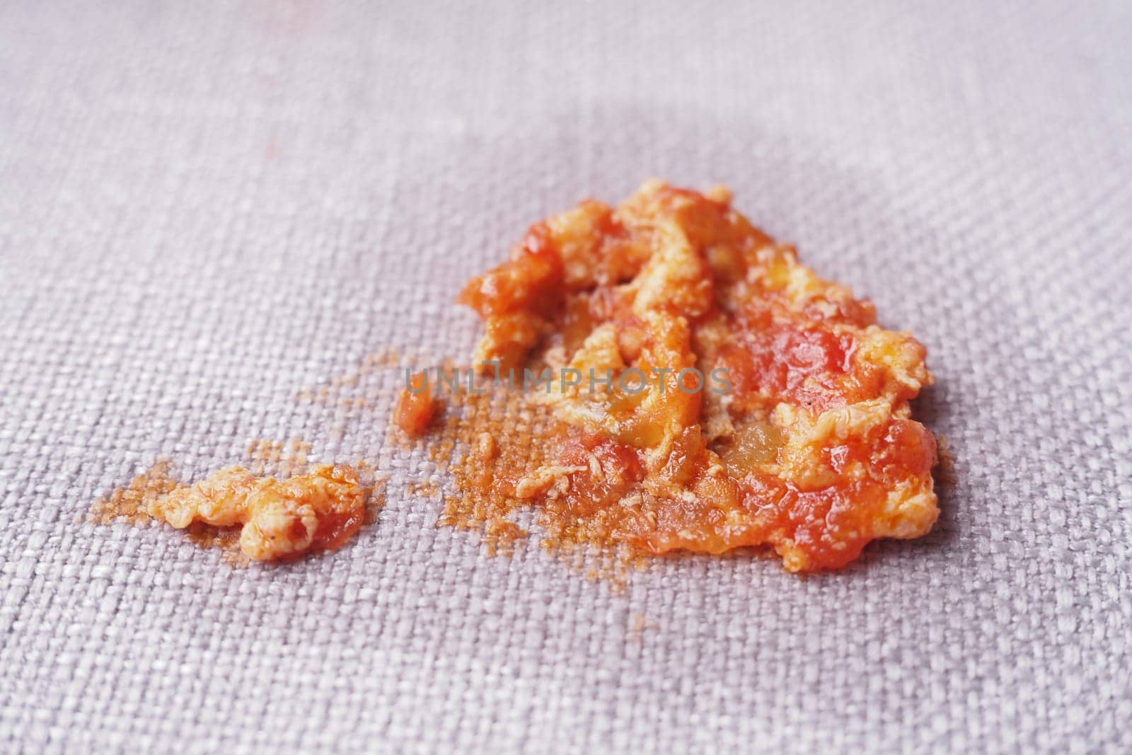A messy spill of tomato sauce showing chunks and smooth texture.