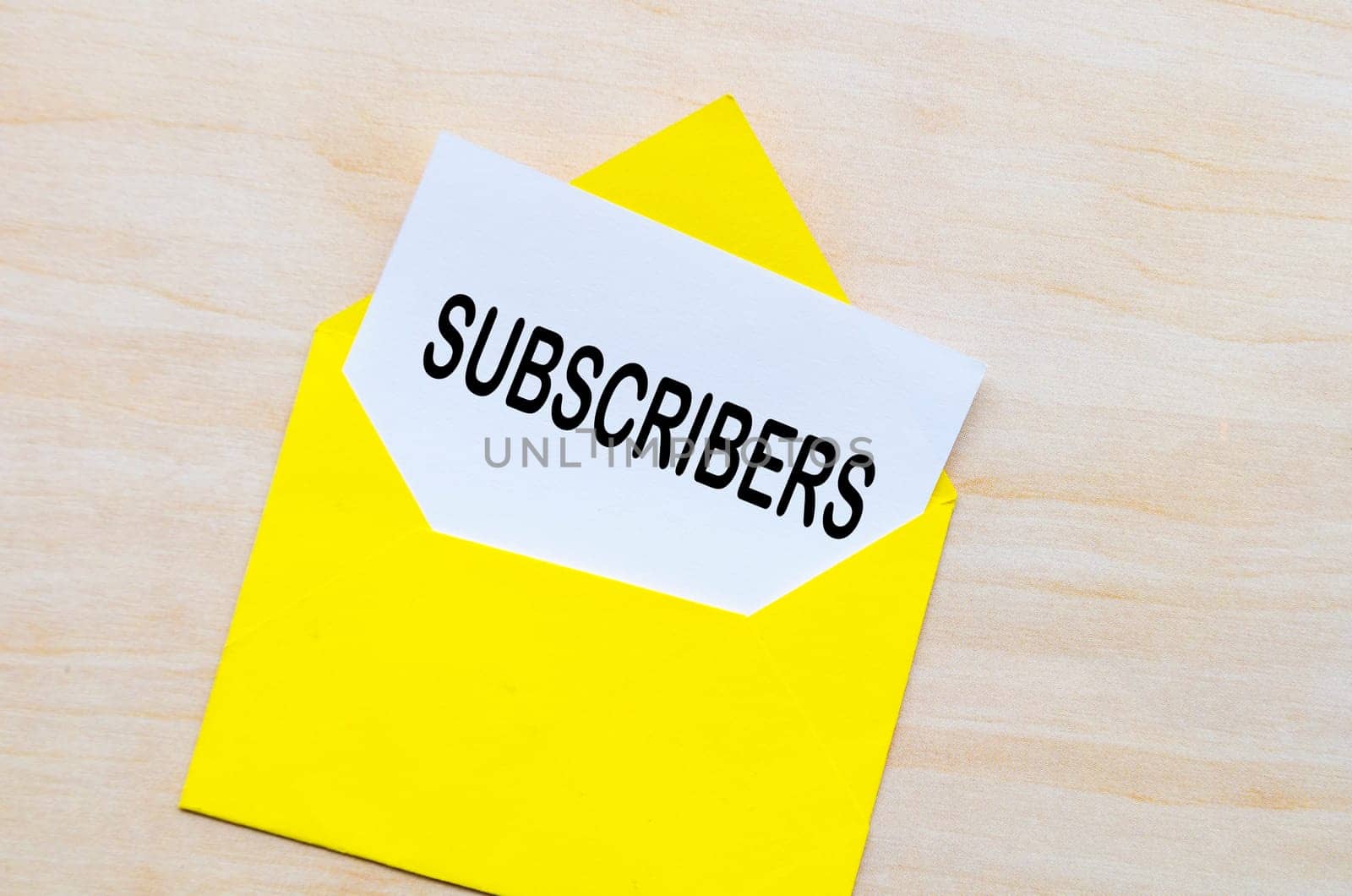 Subscribers text on white notepad inside a yellow envelope. Making money online concept.
