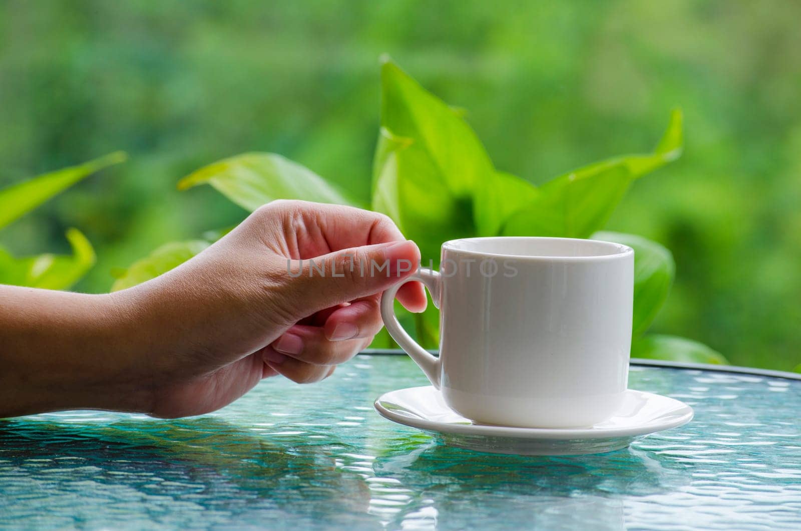 Hand holding a cup with customizable space for mockup.