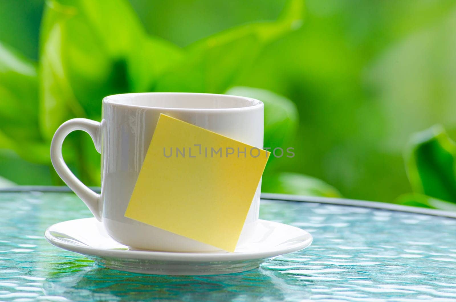 Sticky notepad on white cup. Customize space for text or ideas.