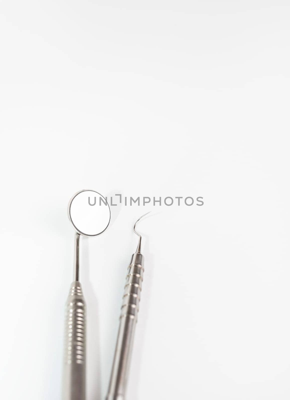 Isolated Basic Dental Instruments Set, Mirror, Explorer. Oral Hygiene Mockup, Dental Care. Healthcare. Vertical. Copy Space High quality photo