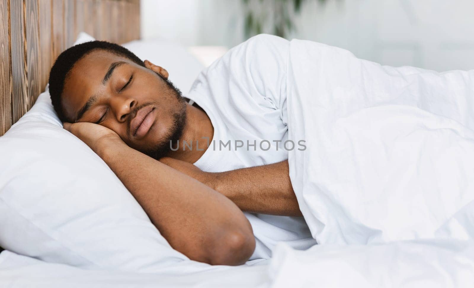 Asleep African American Guy Sleeping Resting Peacefully In His Comfortable Bed At Home, Lying With Eyes Closed. Recreation, Deep Male Sleep, Time To Rest And Nap Concept.