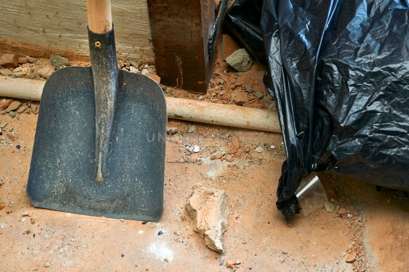 a tool with a broad flat blade and typically upturned sides