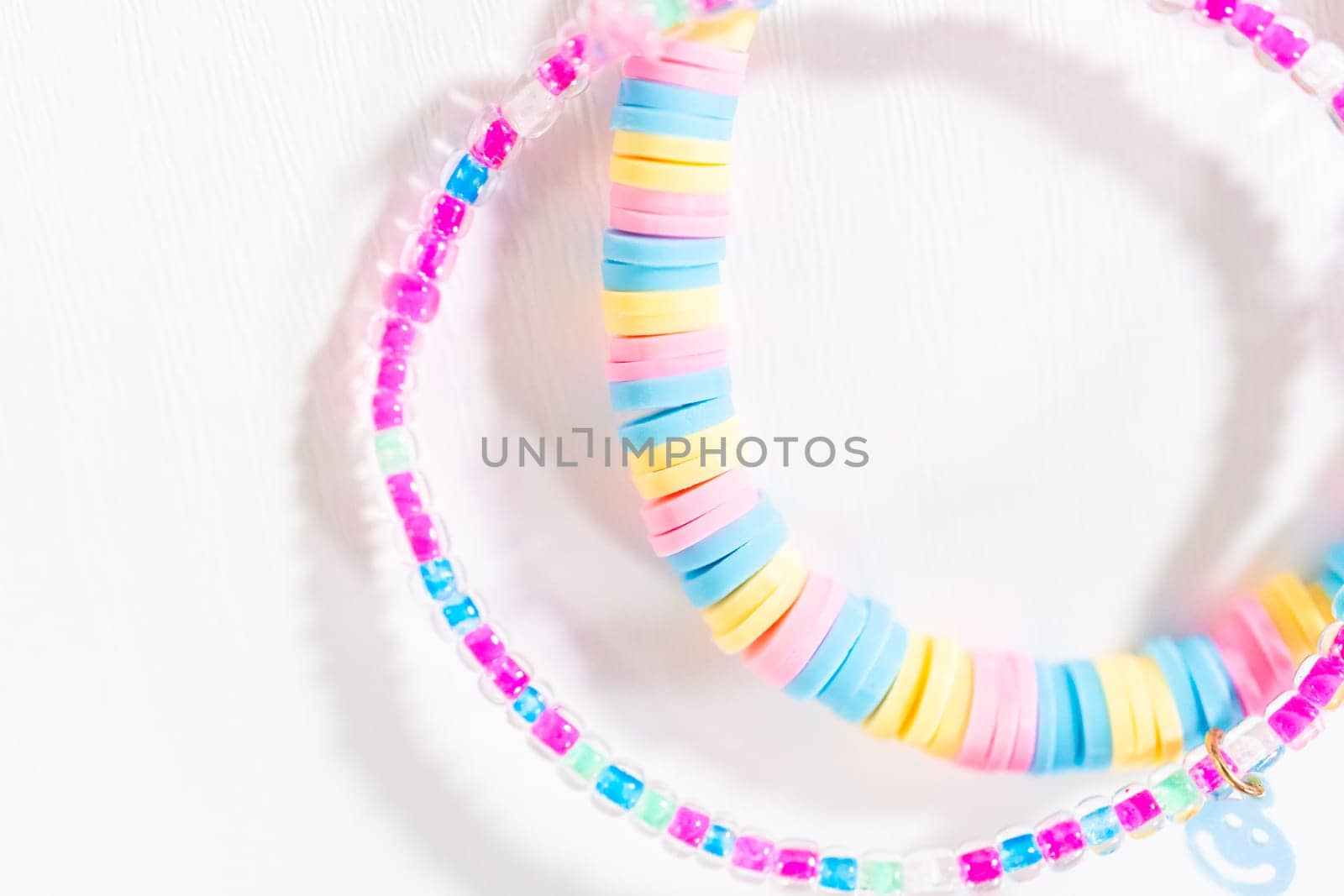 Little girl's charming bracelets adorned with clay and sea beads.