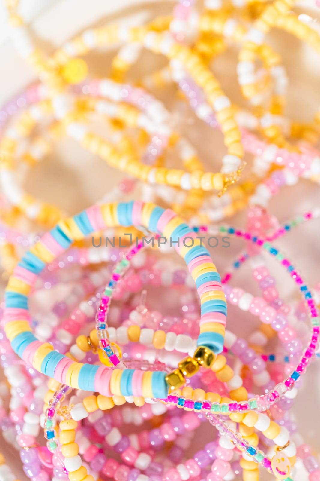 Little girl's charming bracelets adorned with clay and sea beads.