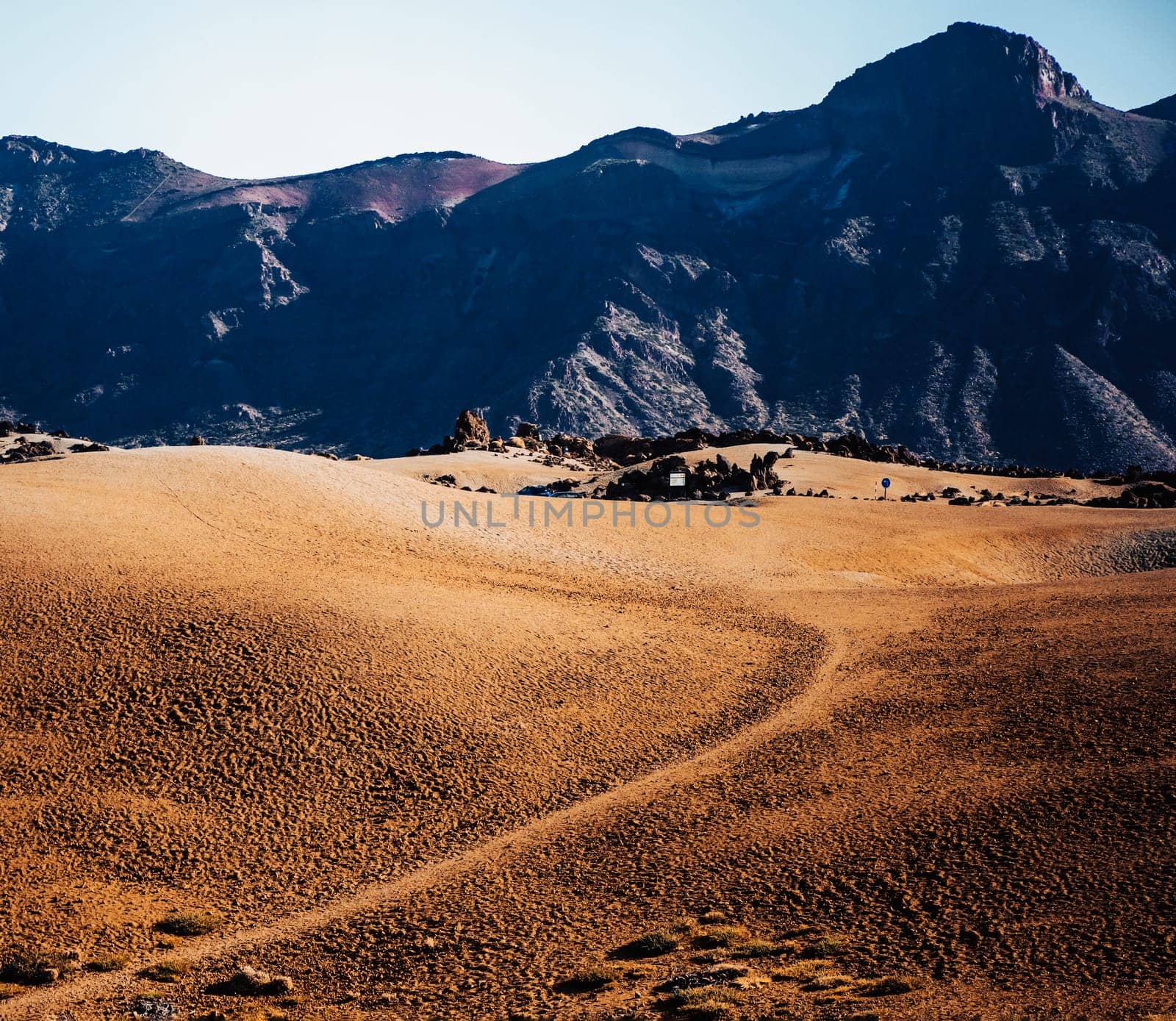 Lunar landscape with desert, yellow sand among the majestic picturesque mountains. A beautiful valley with volcanic frozen lava.